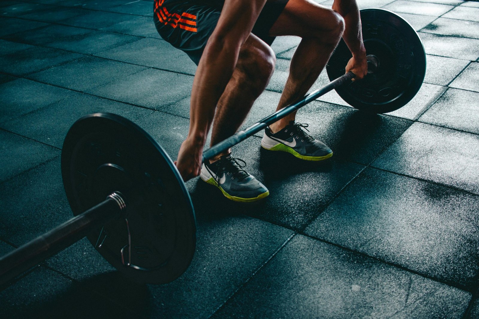 Let's end your back pain Man performing a deadlift exercise in a gym, demonstrating strength and fitness.